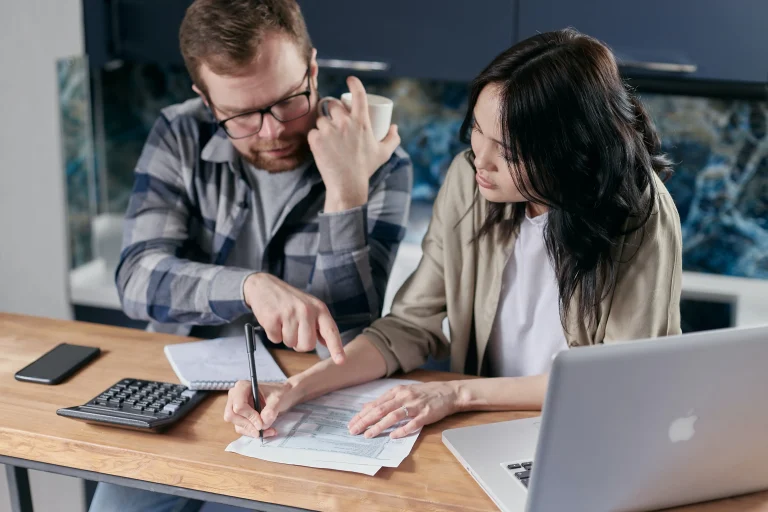 Couple going over their credit report. They found things that are not accurate and they need to contact their credit report lawyer.