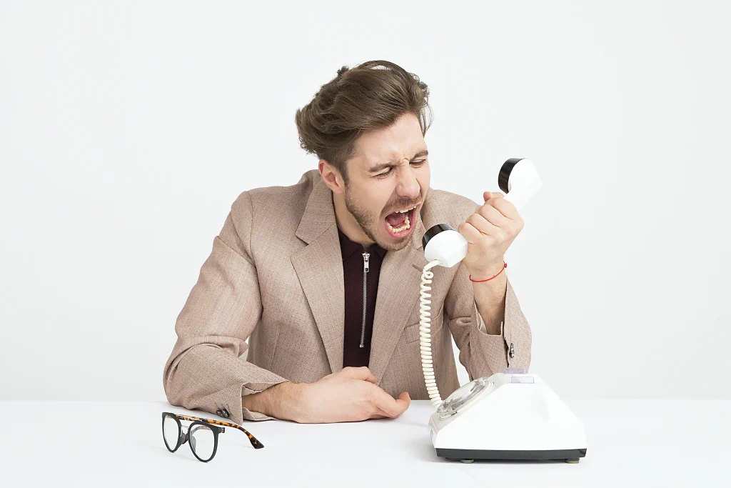 Man frustrated by robo calls. He needs a debt collection lawyer to help.