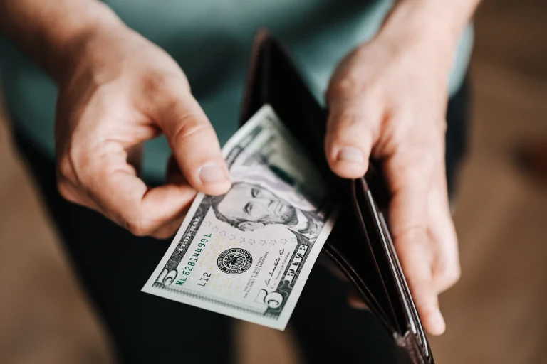 Consumer using cash to buy something.